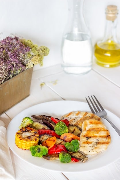 A single serving of a colorful and healthy meal, such as a grilled chicken breast with roasted vegetables, presented on a plate.