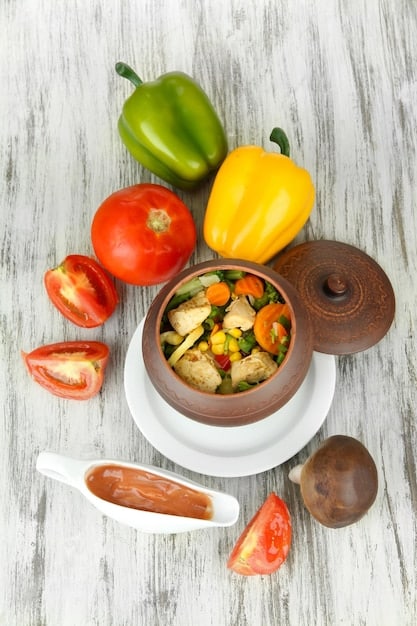 Close-up shot of various colorful chopped vegetables (carrots, bell peppers, onions, zucchini) in separate bowls ready to be cooked for a batch cooking session. Focus on freshness and preparation for healthy cooking, arranged on a stainless steel countertop.