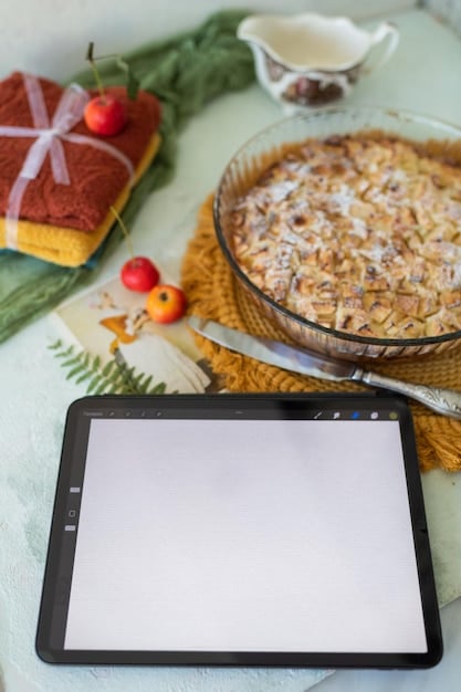 Various recipe books and a tablet displaying a recipe, surrounded by common pantry staples like pasta, canned tomatoes, and spices, illustrating creative meal planning.