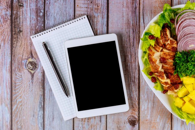 A visual representation of a meal plan on a whiteboard or digital tablet, showing a well-organized list of meals for the week, complete with ingredients and portion sizes for a single person. The style is clean, modern, and efficient.