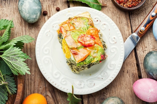 A colorful and appetizing high-protein scrambled egg bowl. The eggs are fluffy and golden, topped with sautéed spinach, sliced mushrooms, diced bell peppers, and avocado slices. A sprinkle of chili flakes adds a touch of spice.