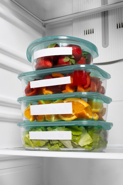 Close up of a refrigerator interior, neatly organized with labeled containers filled with pre-cut vegetables and leftovers, showcasing effective food storage techniques.