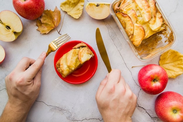 Close-up shot of a person's hand dipping a crisp apple slice into a jar of creamy almond butter. The background is blurred, focusing on the textures of the apple and the rich, nutty butter. Natural light enhances the colors and creates an appealing, appetizing image.