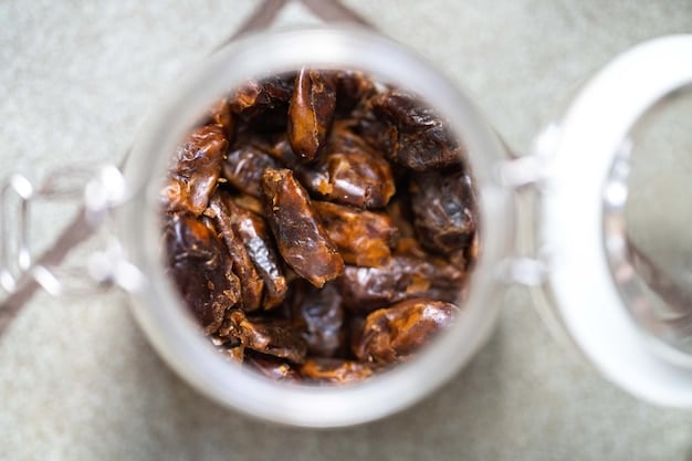 A close-up shot of dates being pitted and blended into a smooth, caramel-colored paste in a food processor, with whole dates and their packaging visible in the background, highlighting the process of making natural sweeteners.