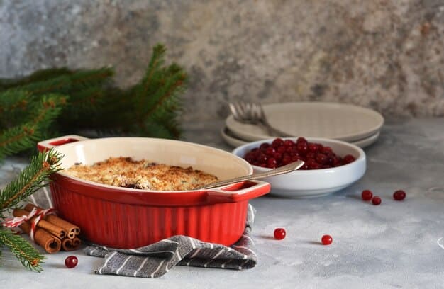 A freshly baked lentil shepherd's pie in a ceramic baking dish, with a golden-brown mashed potato topping, garnished with a sprig of rosemary, on a kitchen counter with a warm, inviting ambiance.