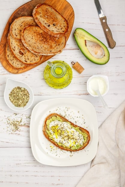 A close-up, overhead shot of a slice of whole-wheat toast topped with mashed avocado, a perfectly cooked scrambled egg, and a sprinkle of red pepper flakes, sitting on a rustic wooden board.