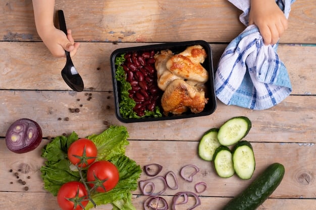 Close-up shot of a person arranging colorful vegetables and cooked chicken into a meal prep container. The focus is on the freshness and variety of the ingredients.
