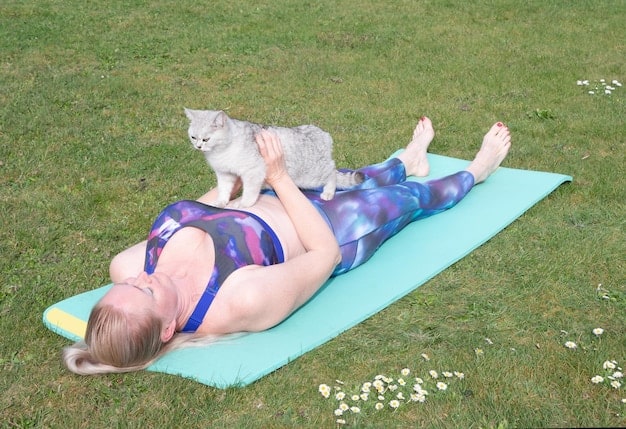 A person demonstrating a cat-cow stretch, showing the range of motion in their spine. The individual is using a yoga mat.