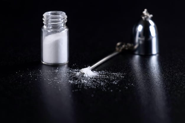 A close-up shot of creatine monohydrate powder being scooped into a shaker bottle, highlighting the texture and form of the supplement. The background is blurred, focusing on the product itself and its preparation for consumption.
