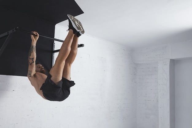 A person hanging from a pull-up bar with their arms fully extended, preparing for a dead hang progression. The background is a simple home gym setup.