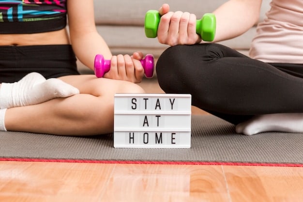A person using adjustable dumbbells in their home gym, with a motivational poster on the wall and a water bottle nearby.
