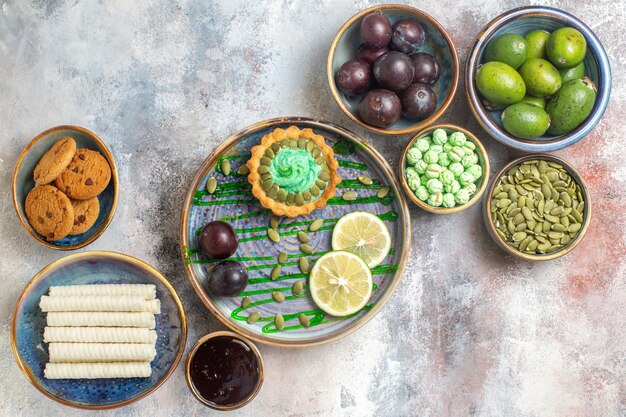 A flat lay photograph showcasing a variety of resistant starch-rich foods. The arrangement includes green bananas, cold potato salad, cooked and cooled rice, a bowl of lentils, and a serving of oatmeal. The image is intended to be visually appealing and informative, highlighting the diversity of resistant starch sources.