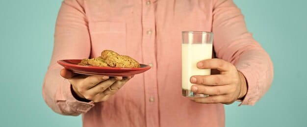 A person drinking a glass of milk with a variety of other calcium-rich foods, such as cheese, yogurt, and almonds, displayed around the glass. The scene should show a healthy and balanced diet focused on calcium intake.