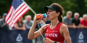 Female endurance athlete hydrating during a race, focused on performance and recovery