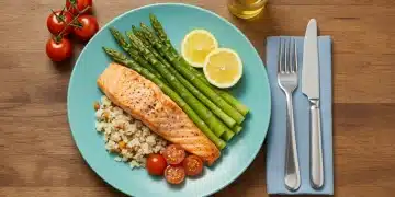 Delicious grilled salmon with fresh green asparagus and bright red cherry tomatoes, symbolizing healthy low-carb dinner options.
