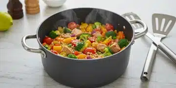 Colorful one-pot meal with vegetables and protein, ready to serve, symbolizing healthy and easy cooking.